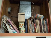 Cabinet of cookbooks and recipe boxes