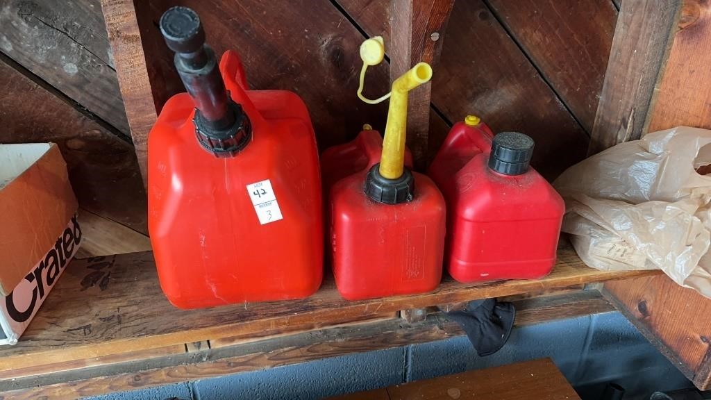 Three red gas cans
