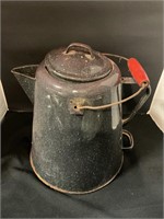 Vintage enamelware coffee pot with red handle