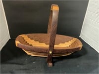 A wooden collapsible, oval basket