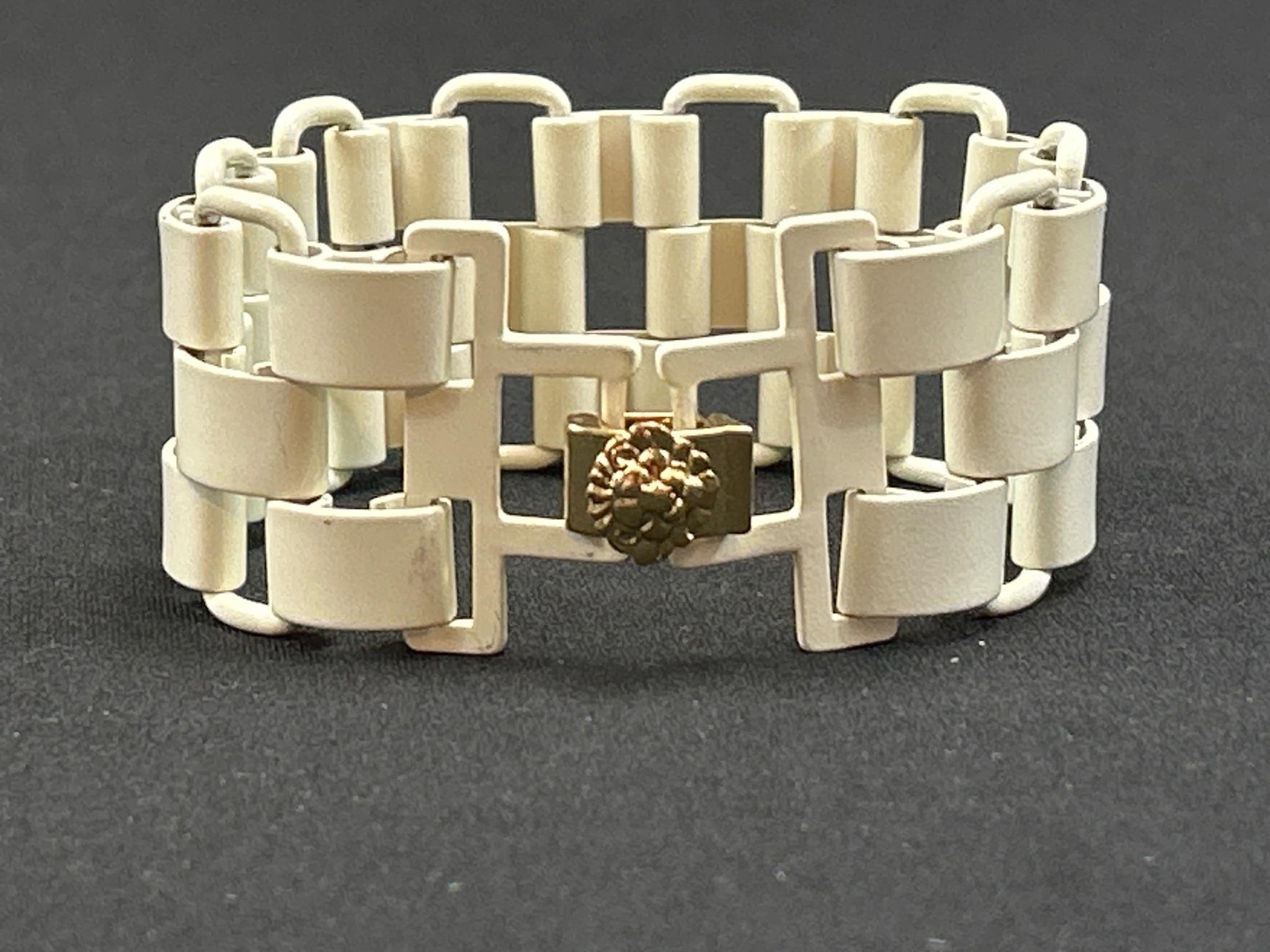 Big wide bracelet with lion face on the clasp.