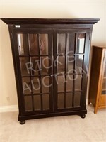 small glass and dark wood display cabinet