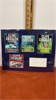 Signed Clive cussler poster/picture of some of