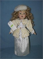Porcelain windup musical doll in fancy dress