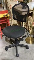 Swivel office chair on five black caster wheels
