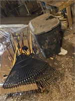 Garbage can wheelbarrow with contents, rakes