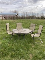 Outdoor glass top dining table with four chairs