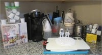 Kitchen items including cutting board, Kurig,