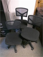 three smaller office chairs