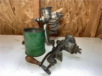 Vintage meat grinders and flour sifter