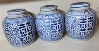 Group of 3 matching blue and white jars with lids