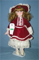Porcelain doll in fancy maroon dress
