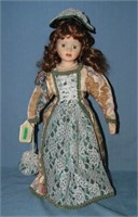 Porcelain doll with beatuful gown and pearl neckla