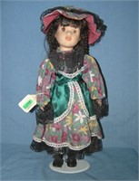 Porcelain doll with fancy dress and hat