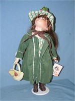 Porcelain doll with suede jacket and hat