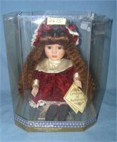 Porcelain windup musical doll in elegant maroon dr