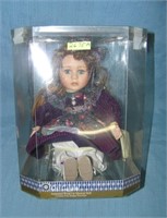 Porcelain windup musical doll in fancy dress and r