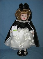 Porcelain windup musical doll in fancy dress
