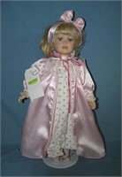 Porcelain doll with pajamas and pink night gown
