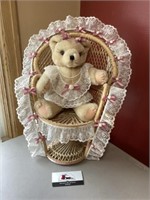 Teddy bear in wicker chair