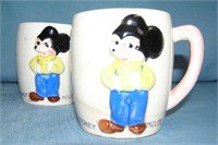 Pair of great early Mickey Mouse milk mugs
