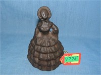 Cast iron woman doorstop with long dress and bonne