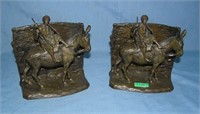 Pair of signed bronze Arabian figures riding a don