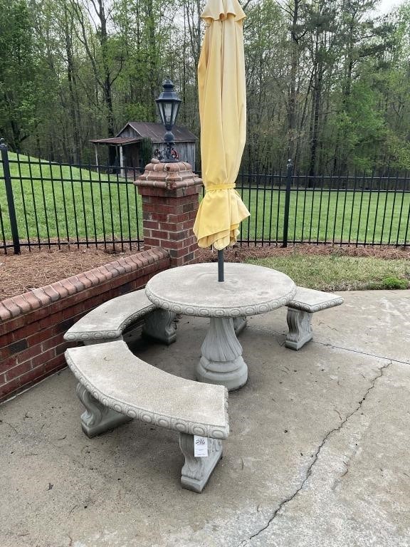 CONCRETE TABLE AND 3 BENCHES WITH YELLOW UMBRELLA
