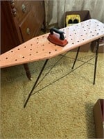 Child’s metal ironing board and iron