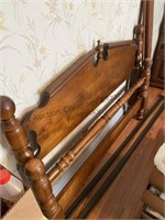 Full size bed with rails and dresser with mirror.