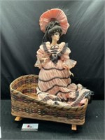 Porcelian Doll and wicker bassinet