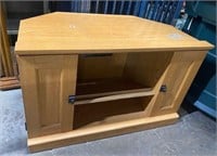 Light colored wood TV stand with storage