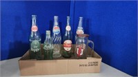 Five vintage pry off top bottles and IU mug