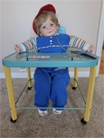 Porcelain Baby In A Metal Highchair