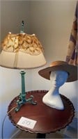 Green lamp, mannequin head with straw hat