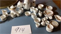 Miniature  teapots, cups, saucers, over 40