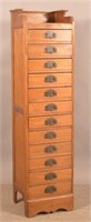 Oak 12-Drawer Cabinet with Batwing Pulls.