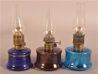 Three Antique Colored Glass Finger Lamps.