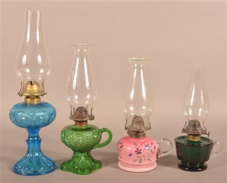 Four Antique Colored Glass Fluid Lamps.