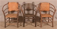 Three Rustic Adirondack Chairs.