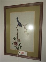 Framed needlepoint on cloth of blue bird and