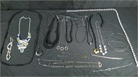 Box of black and silver necklaces