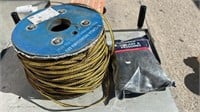 Roll of flat electric fence wire, and a bag of