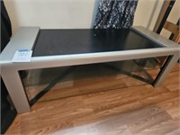 Silver and black TV stand with glass shelves