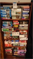 Bookshelf and approx 55 puzzles