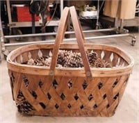 Antique woven basket full of pinecones, 21.5" x