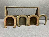 Wooden toolbox with four double ringer horseshoes