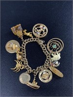 14kt Gold charm bracelet with numerous gold pendan