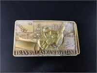 Gold tone Trans-Alaskan Pipeline belt buckle. Meas