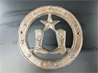Cast iron wall plaque with cowboy boots and spurs,